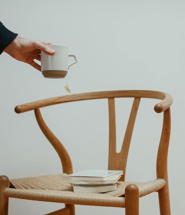 A calm and focused person in a minimalist space with soft lighting.